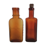 2 amber apothecary bottles