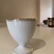 Set of 4 vintage egg cups in white porcelain with a gold rim.