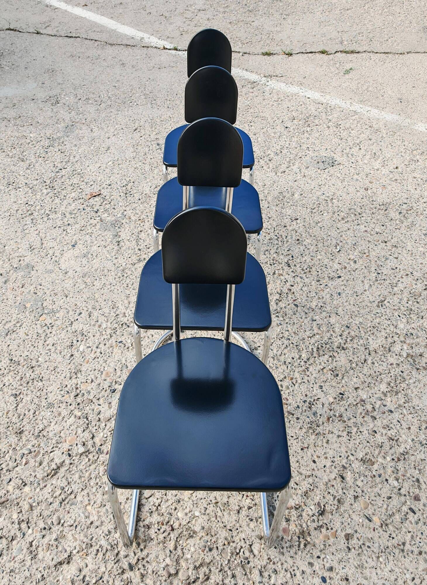 Set of 4 Bauhaus tubular steel chairs with wooden seats.