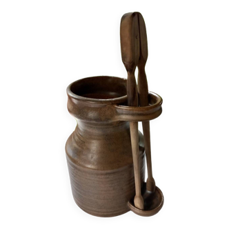 Old pickle jar with wooden tongs