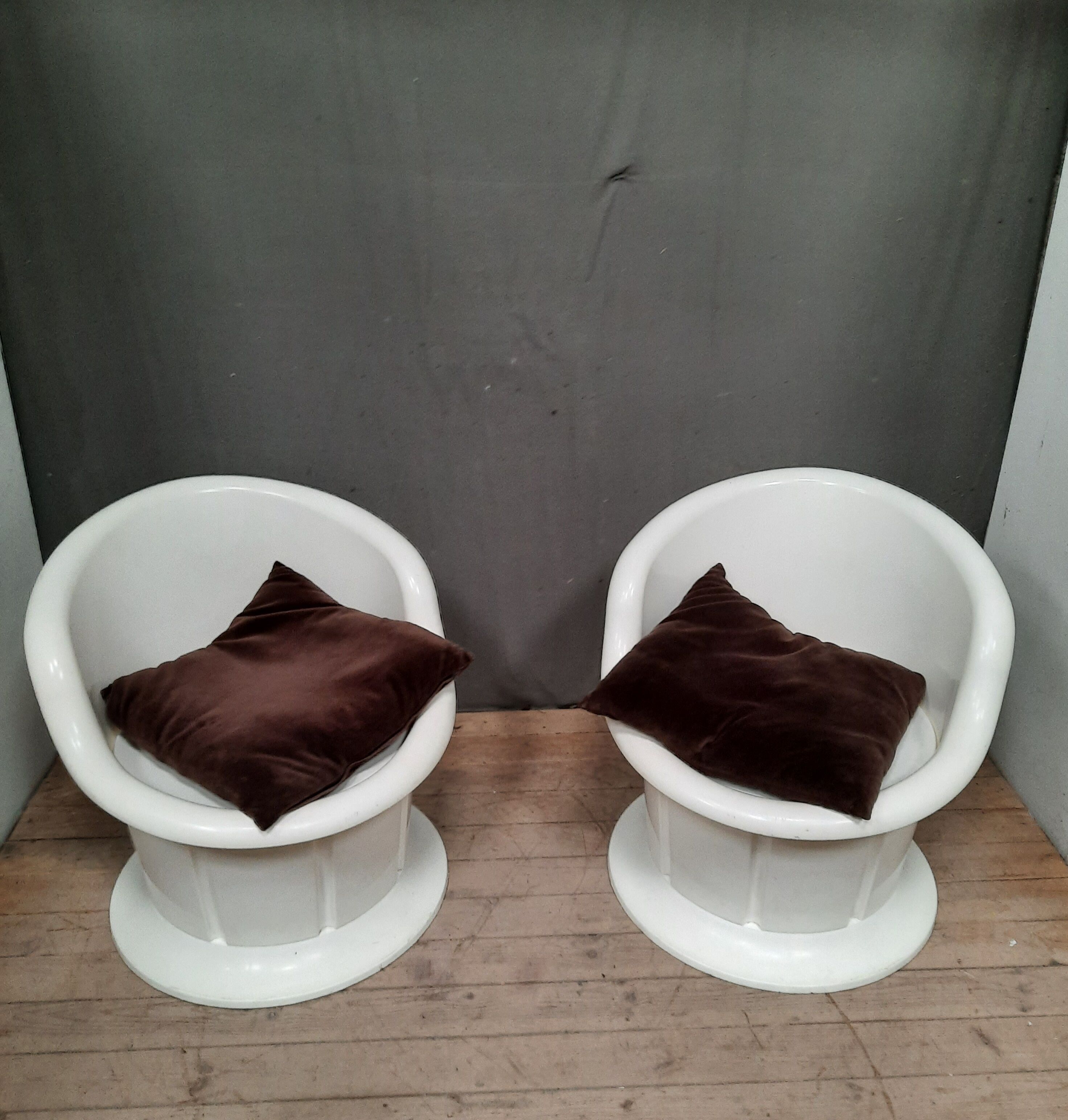 Pair of white plastic armchairs