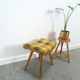 Vintage footrest with checkered cushion