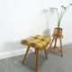 Vintage footrest with checkered cushion