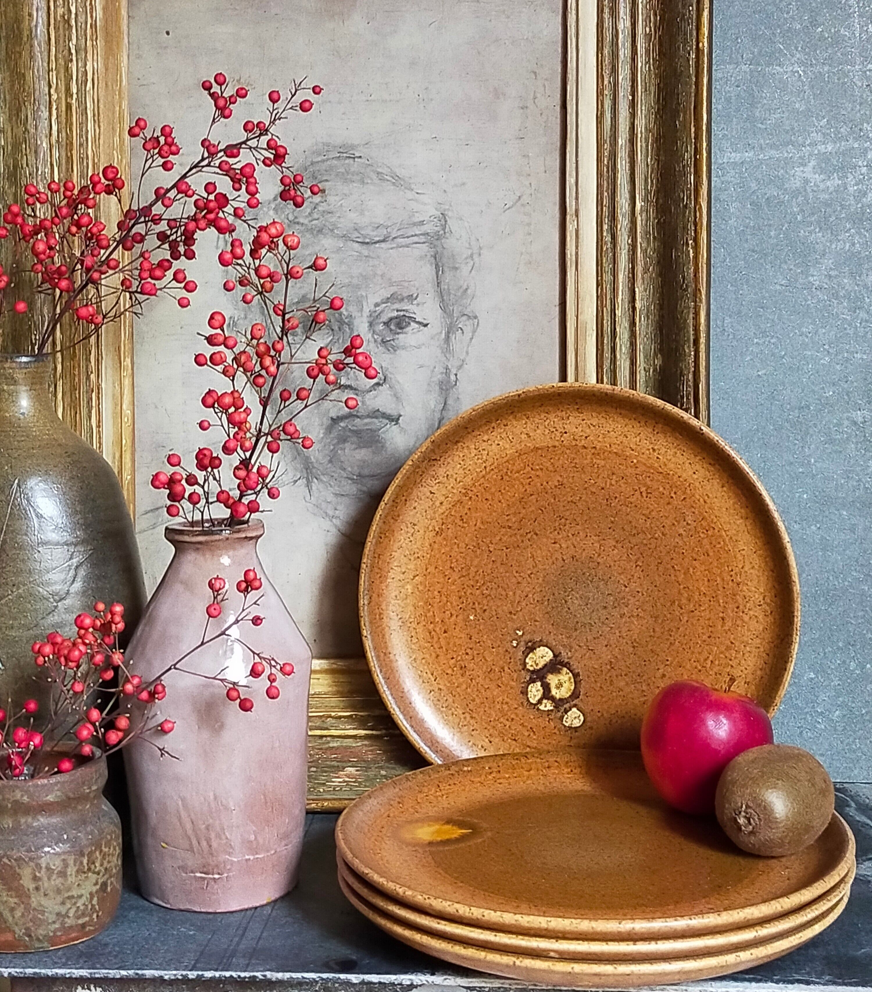 Four vintage glazed stoneware potter's plates