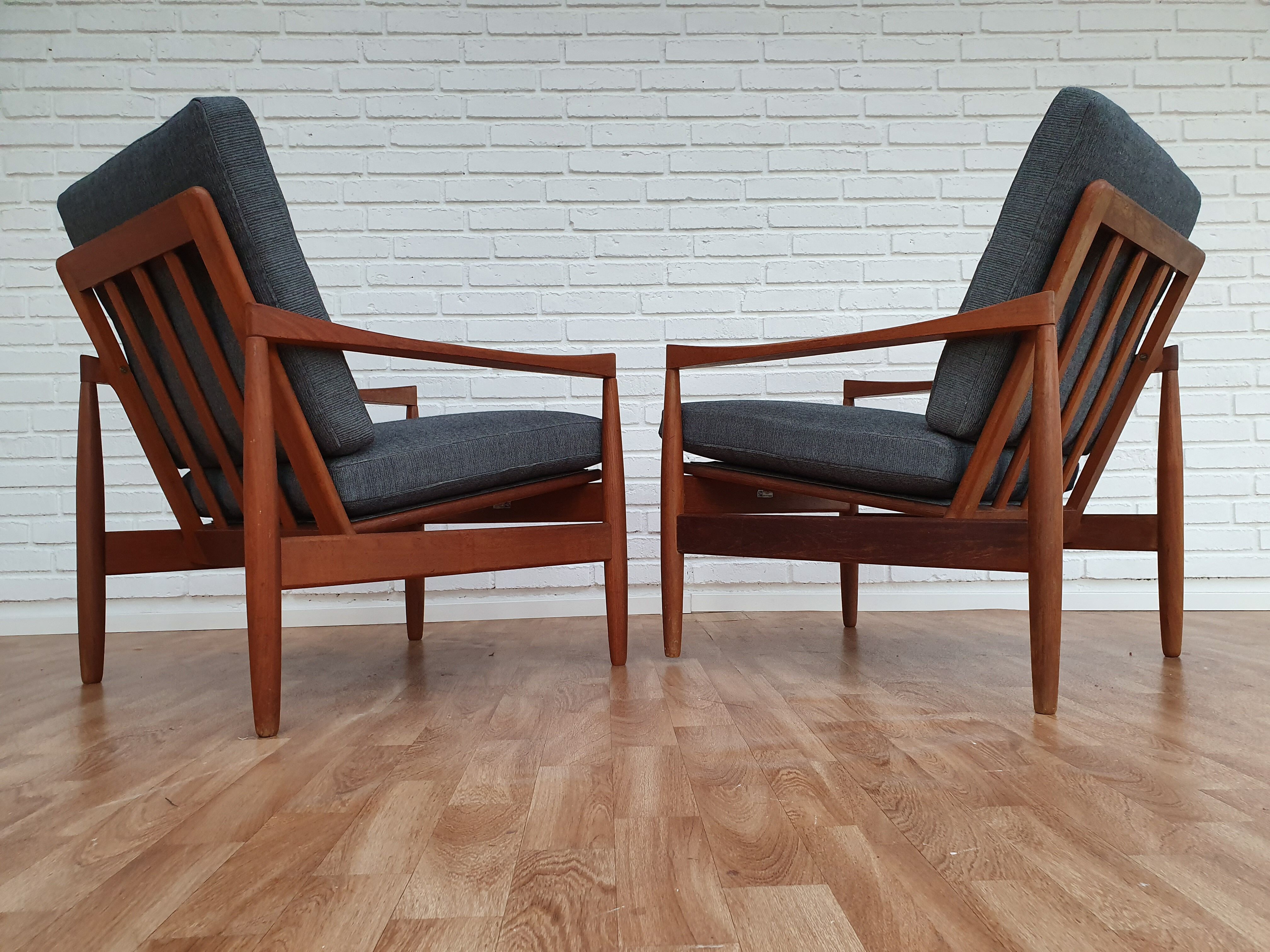A pair of Danish armchairs, teak, wool, leather