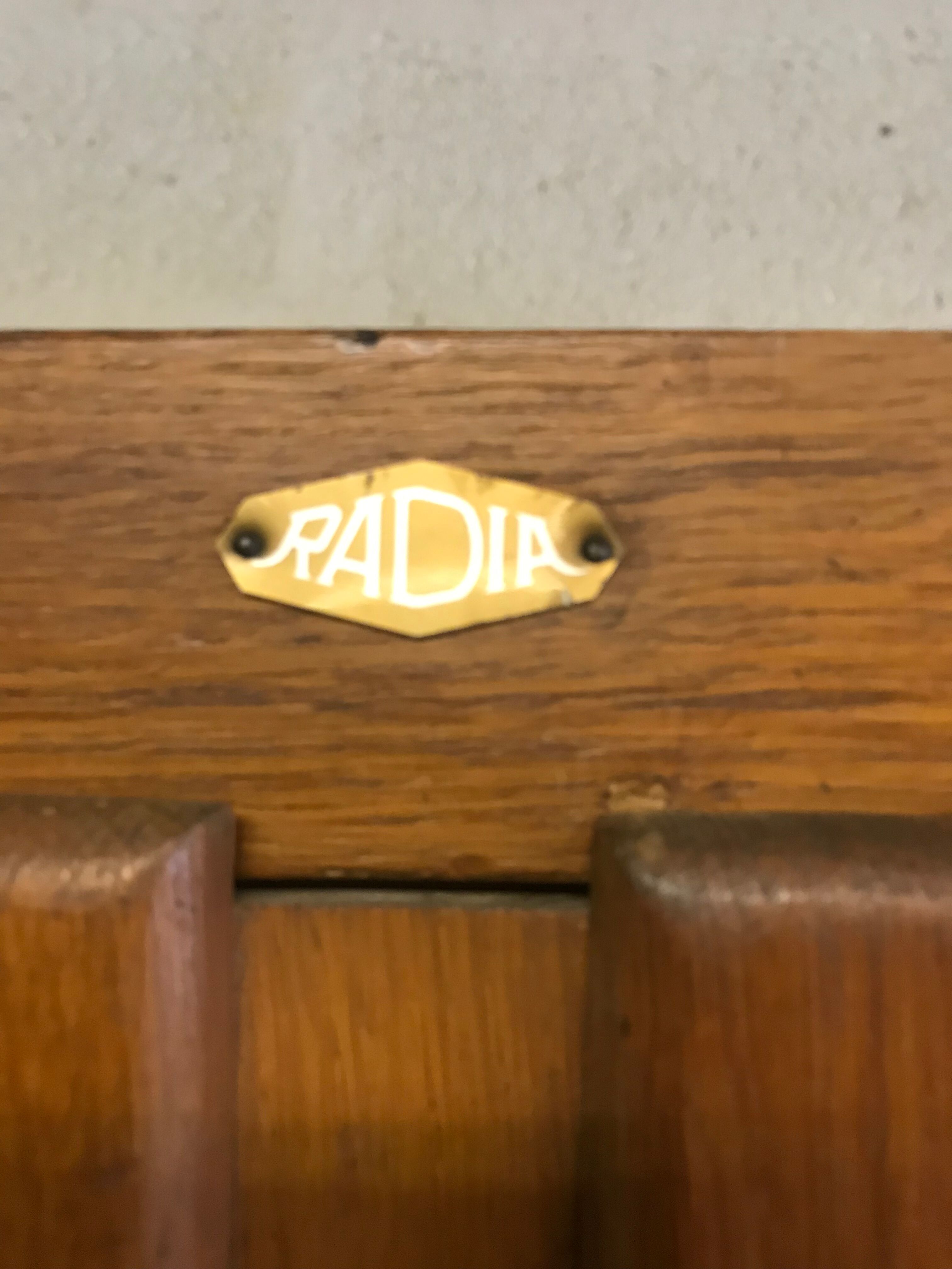 Old school glass bookcase in blond wood
