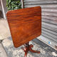 19th-century solid mahogany table with a tilting top and brass mechanism.