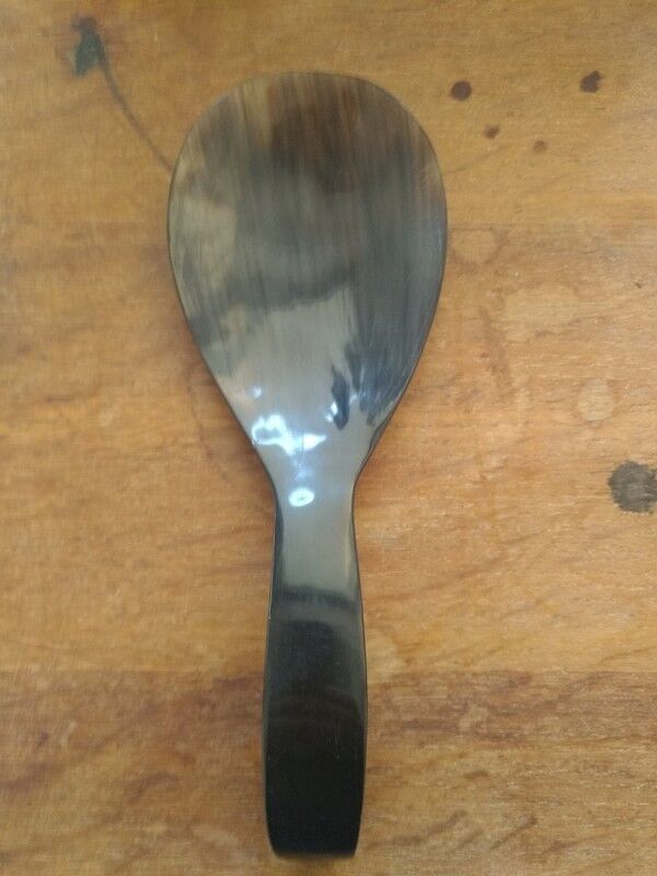 Rice spoon covered with serving in Asian handicraft horn