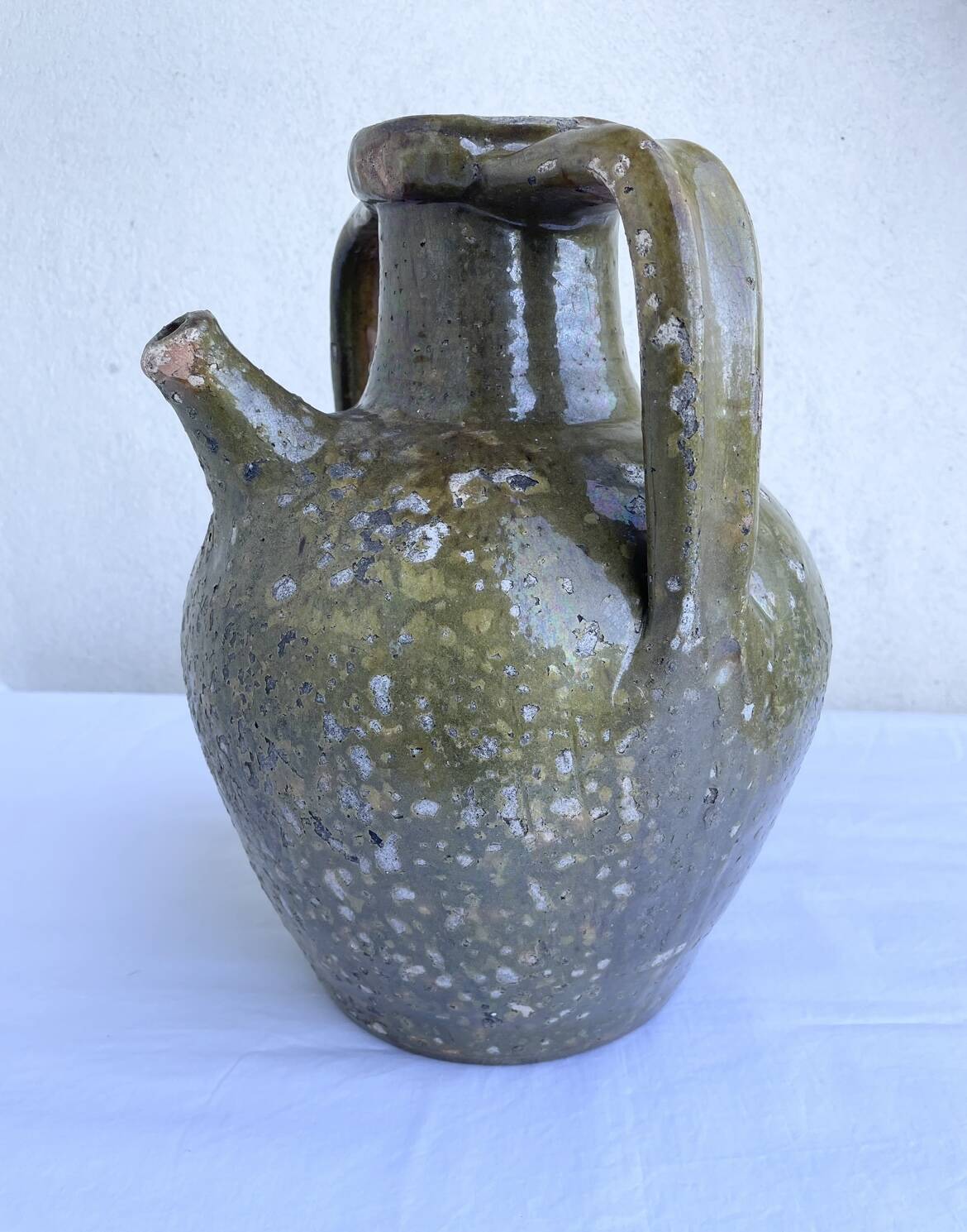 Ancient oil jar in glazed terracotta, khaki green — Auvergne, Lezou