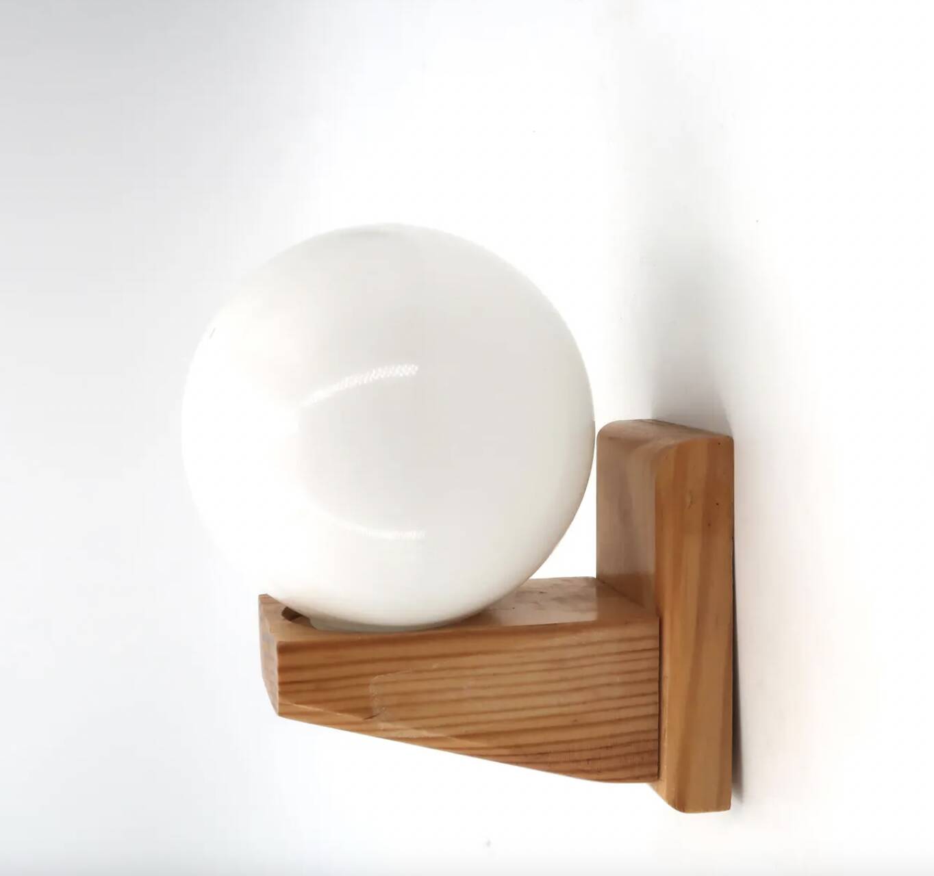 Pine wood wall light with opaque white glass globe, 1980s.
