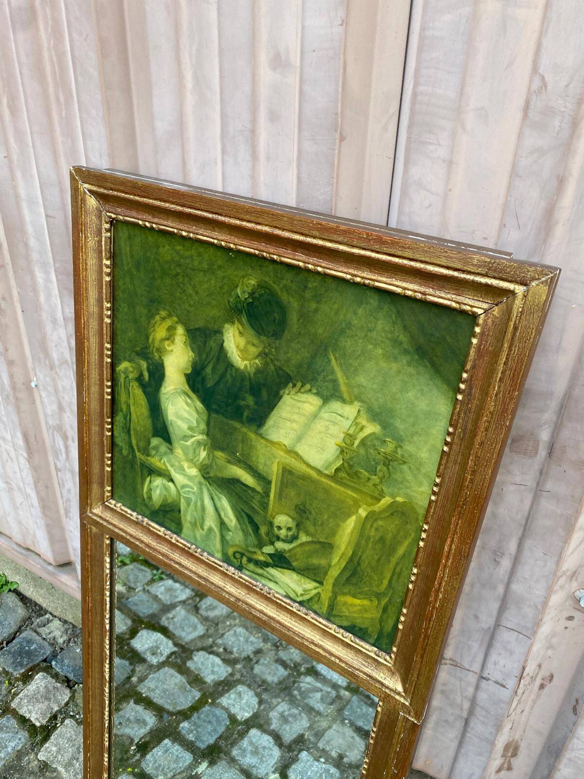 19th-century trumeau with mirror and music lesson canvas.