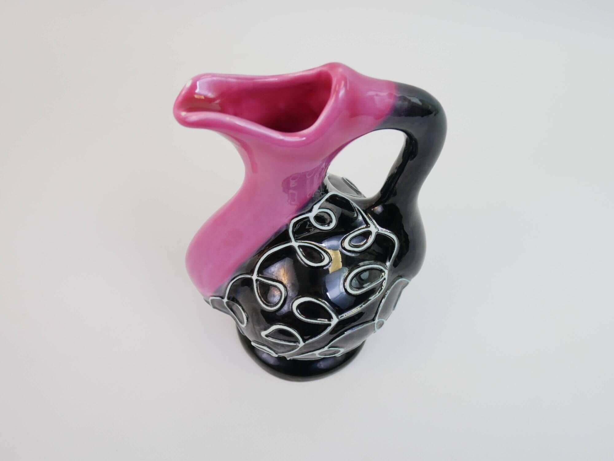 Black and pink Vallauris carafe with white relief patterns