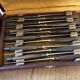 Service of 24 Art Deco knives with wooden handles and engraved metal ferrules from 1930.