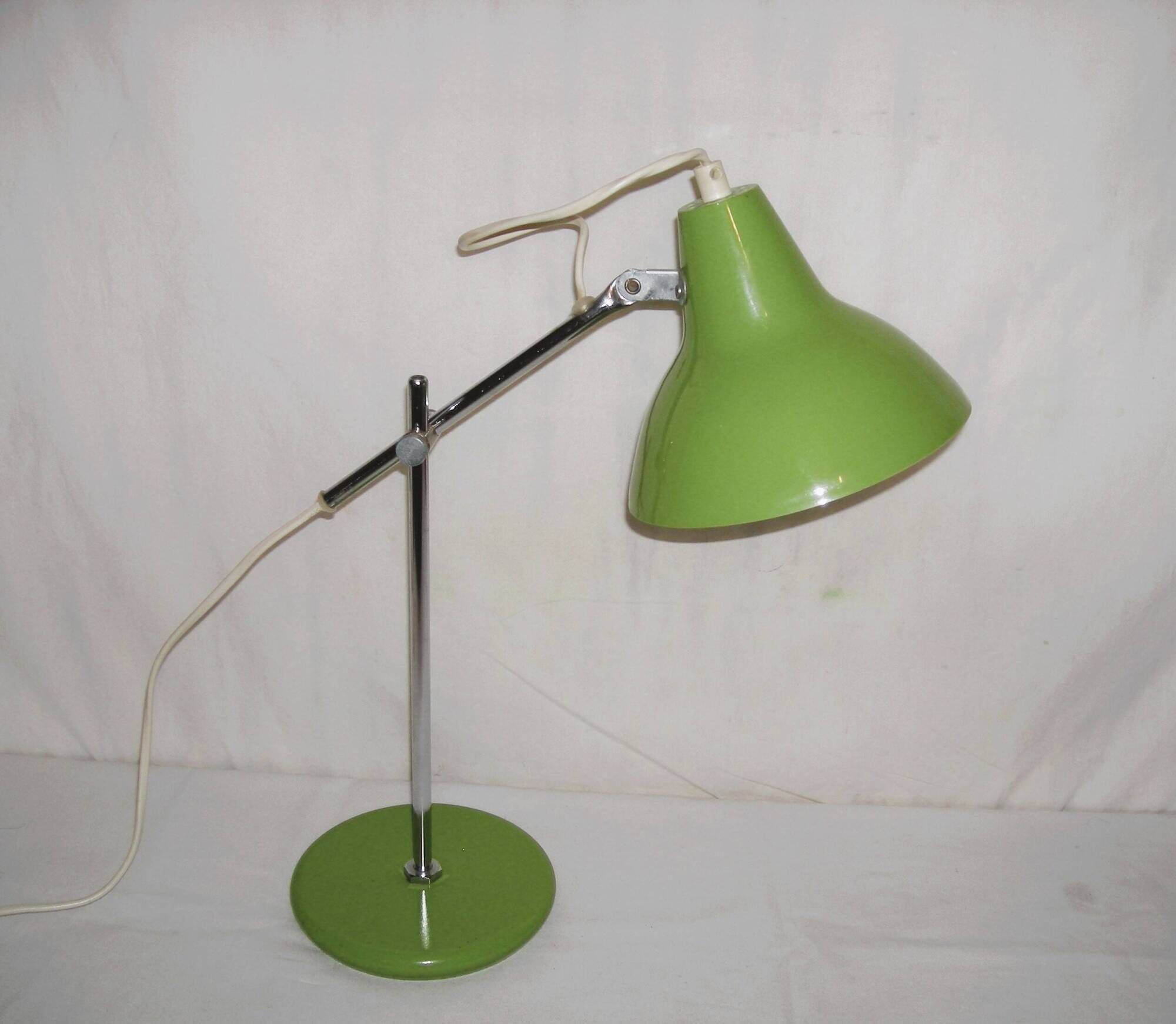 Green desk lamp with an arm from the 1970s.