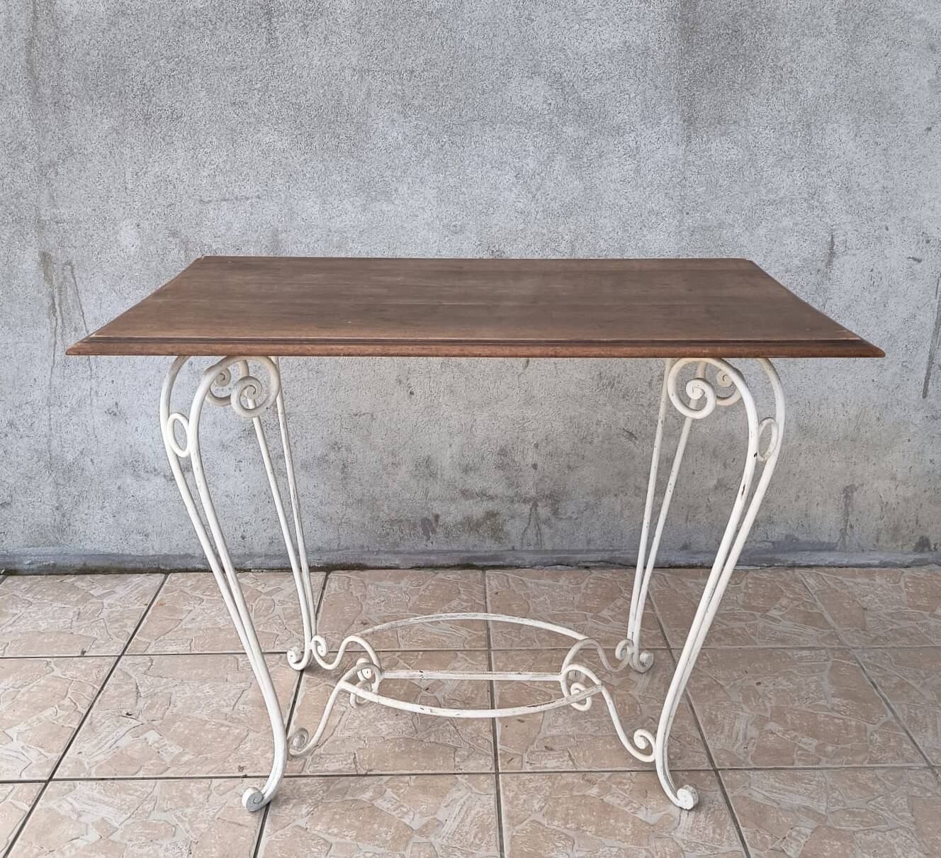 Wrought iron table with a walnut top.