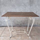 Wrought iron table with a walnut top.