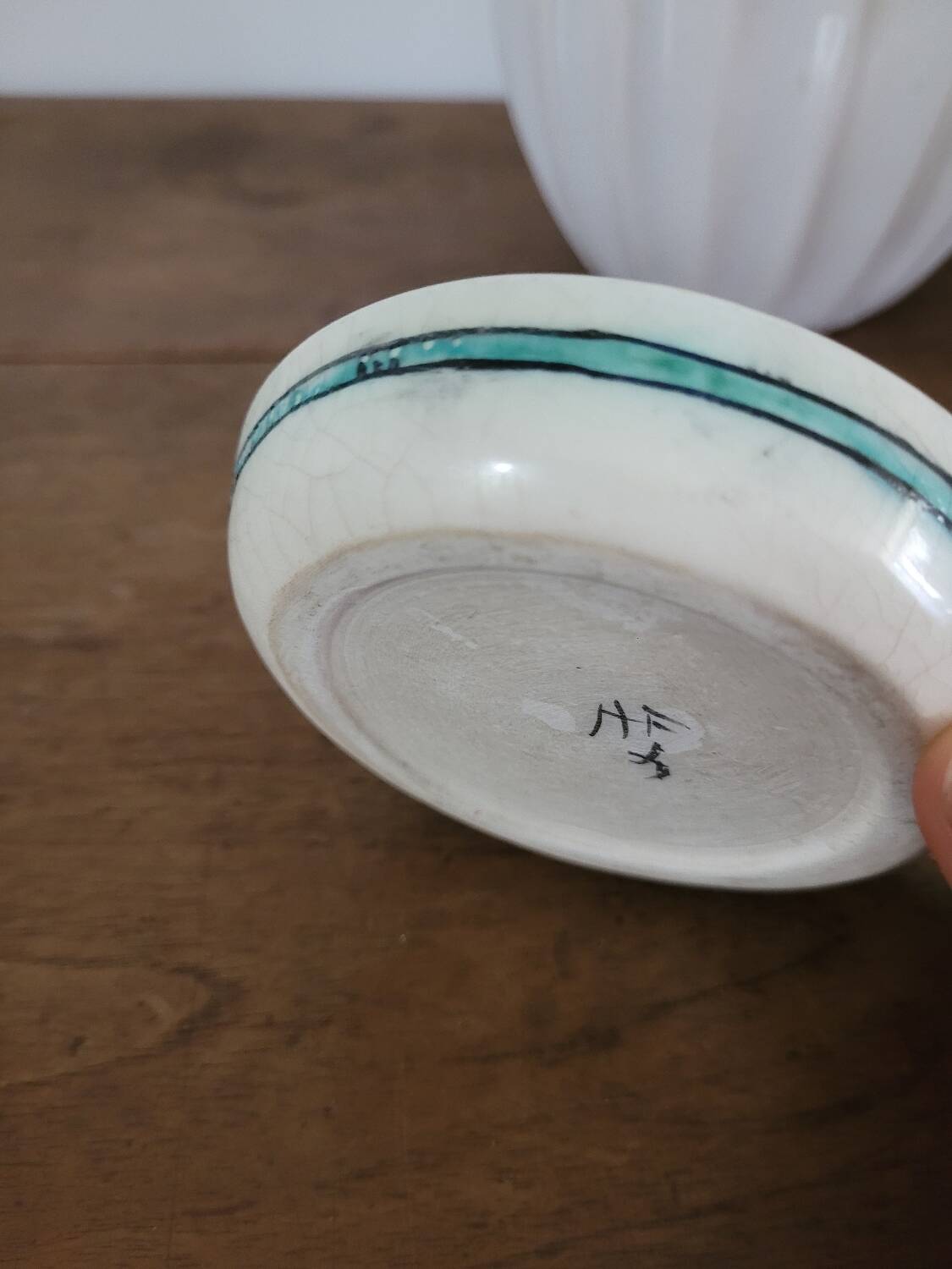 Small glazed stoneware bowl with a fish design