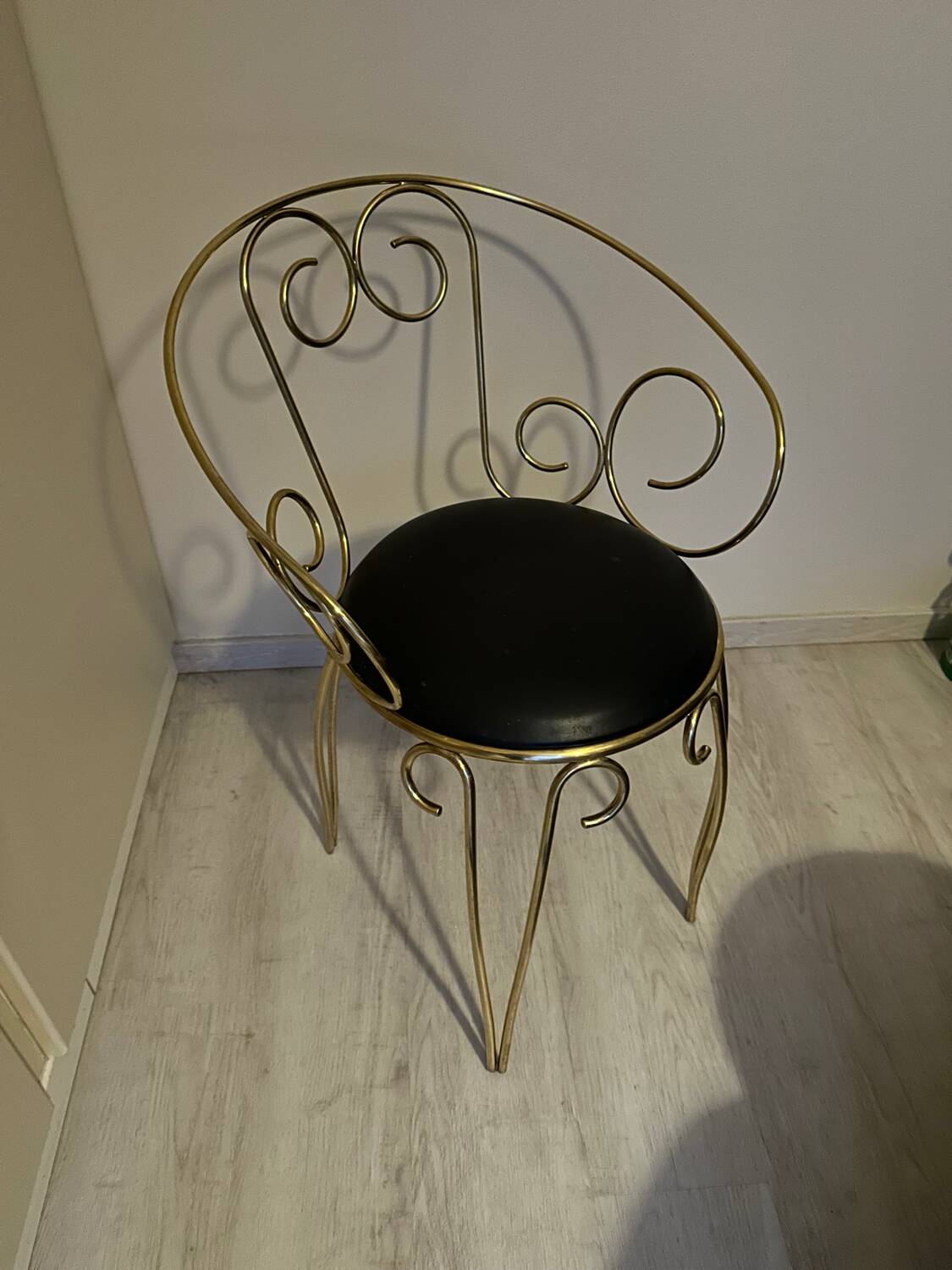 1960s brass and vinyl scroll chair