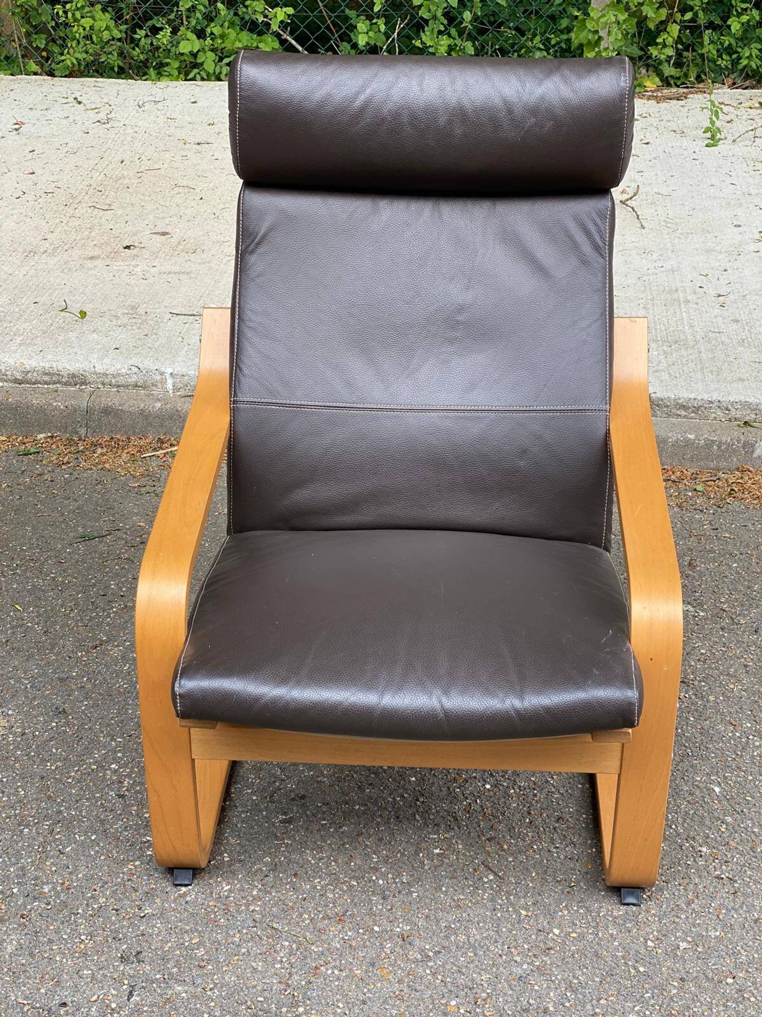 Scandinavian rocking chair in curved wood and brown leather from IKEA Poang