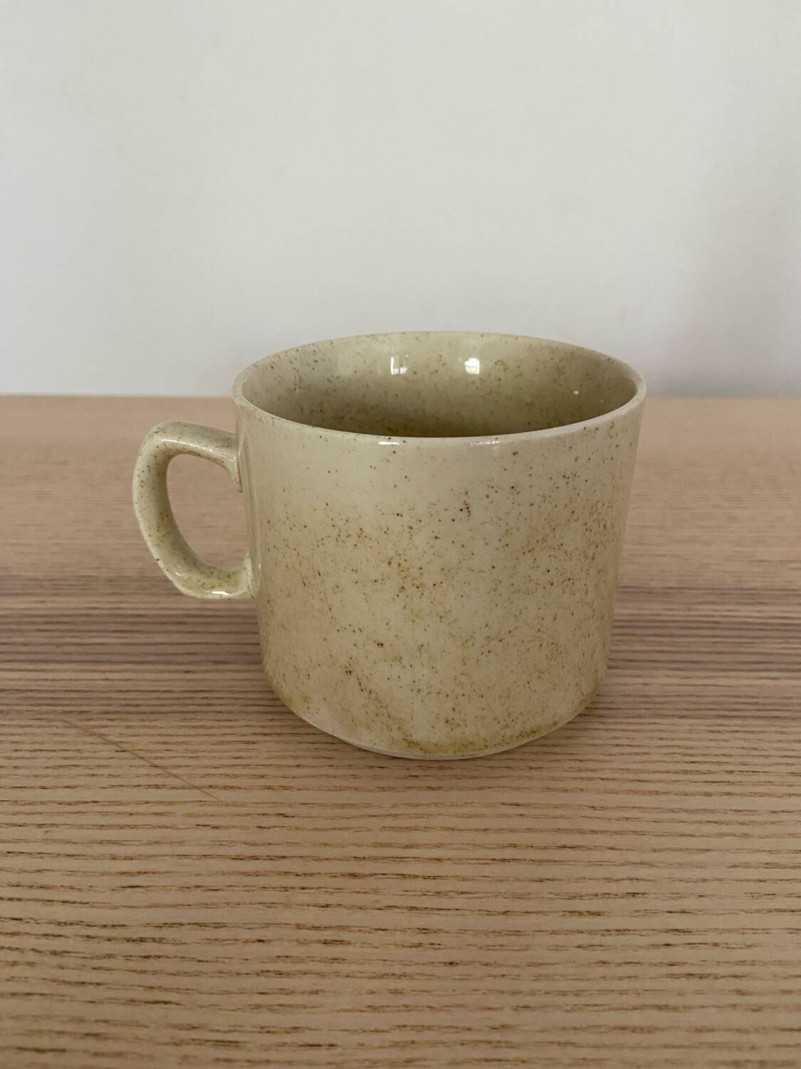 Speckled stoneware cup with blue flower
