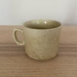 Speckled stoneware cup with blue flower