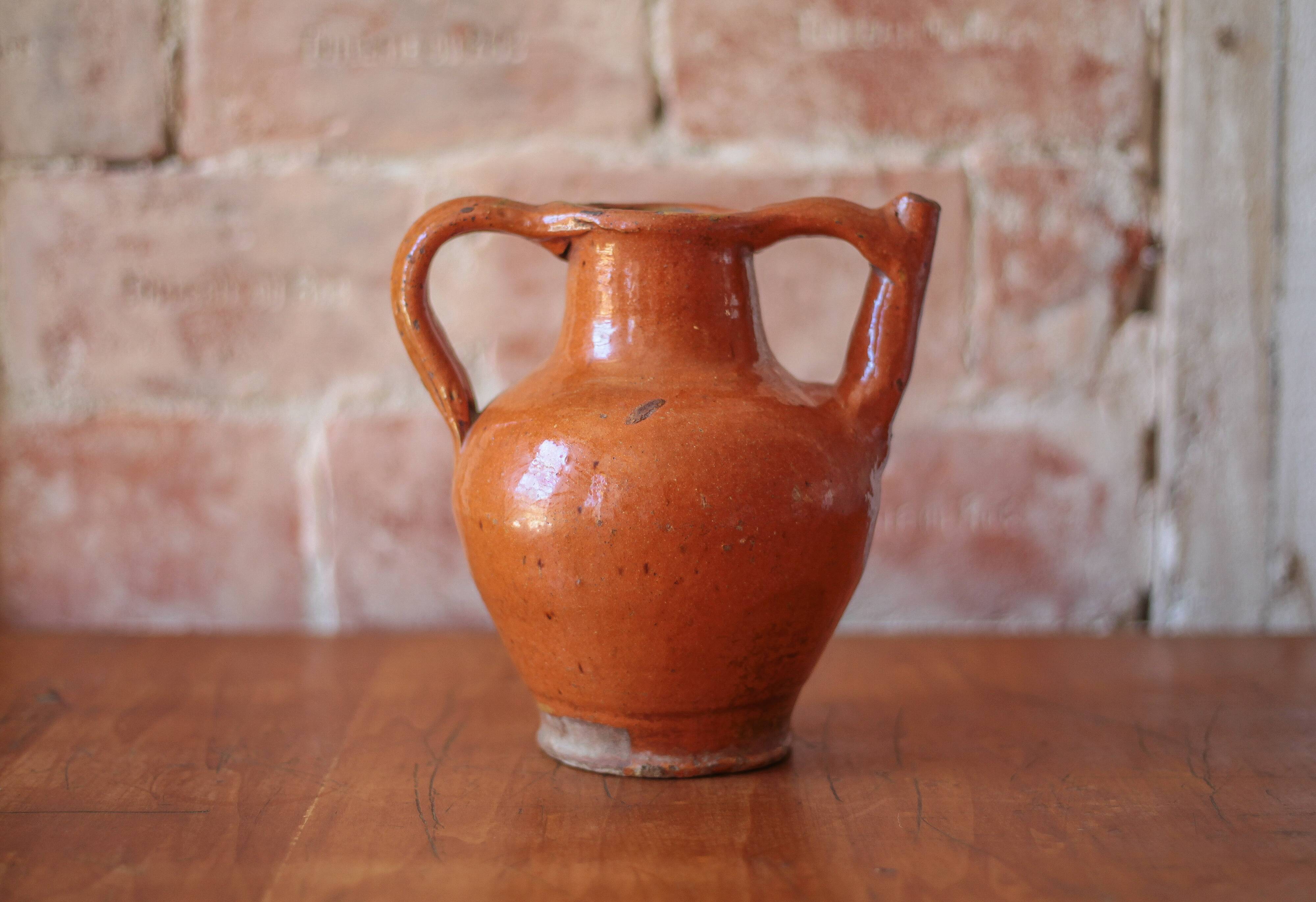 Ancient Orjol jug in orange glazed terracotta from South West France, 19th century.