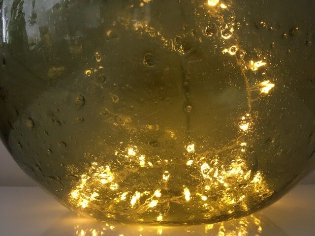 Old demijohn full of bubbles