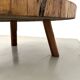 Brutalist coffee table in solid teak, monolithic slab, tripod base.