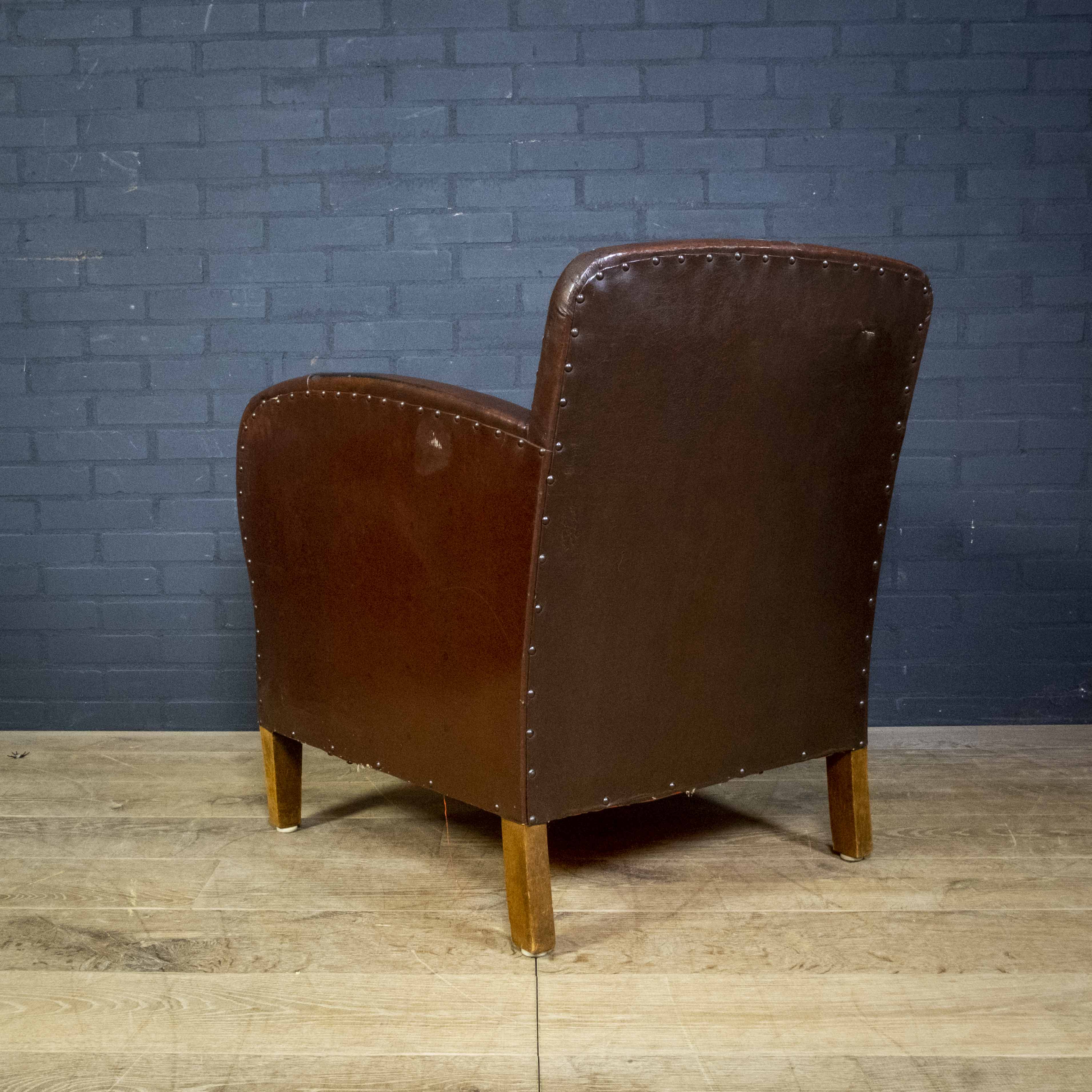 Antique club armchair of leather cloth