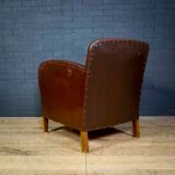 Antique club armchair of leather cloth