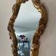 Old italian mirror in gilded plaster with leaf