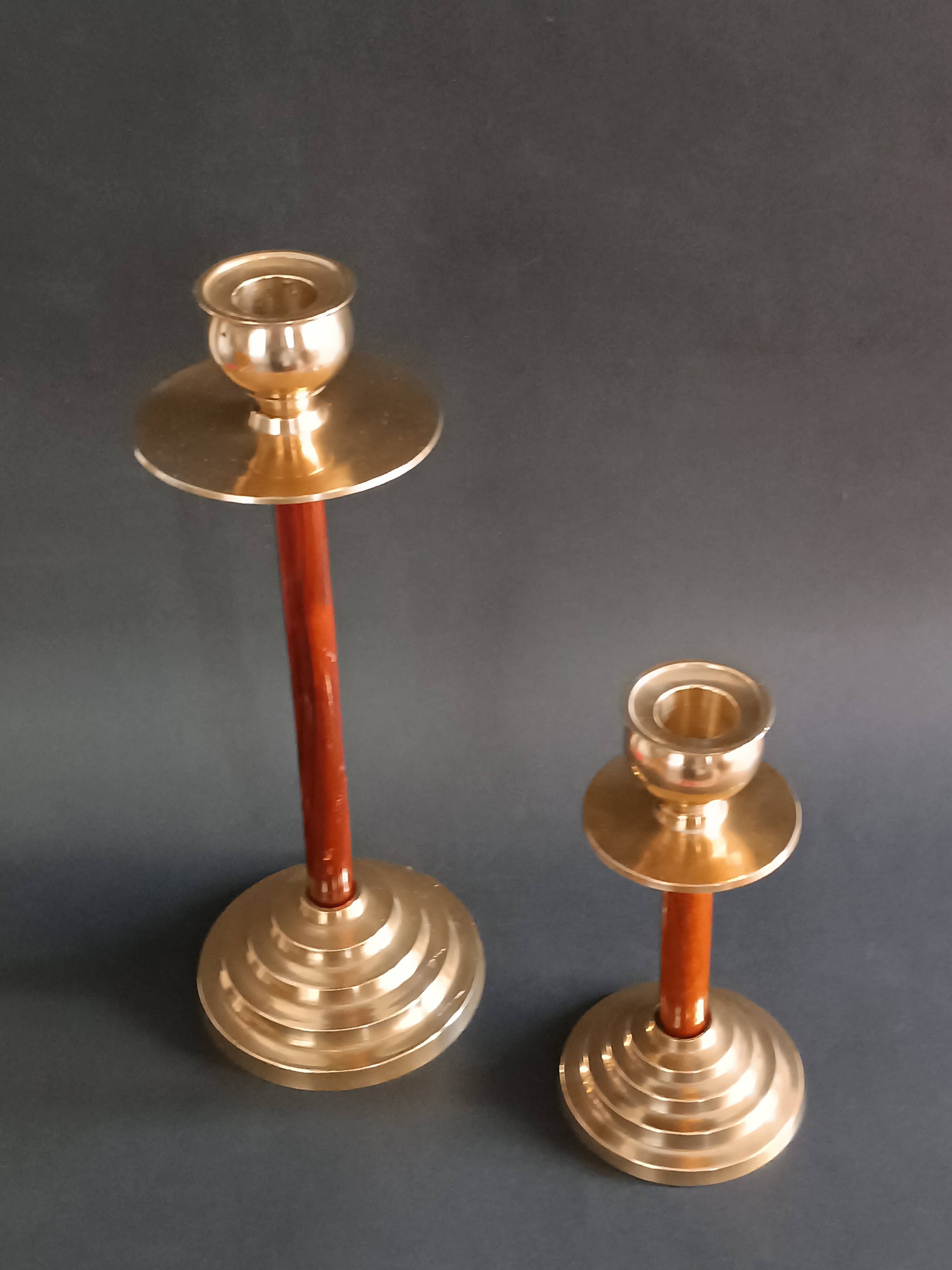 Two vintage wooden and brass candlesticks.