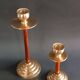 Two vintage wooden and brass candlesticks.