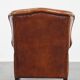 Sheepskin wingback armchair with stitching and black piping