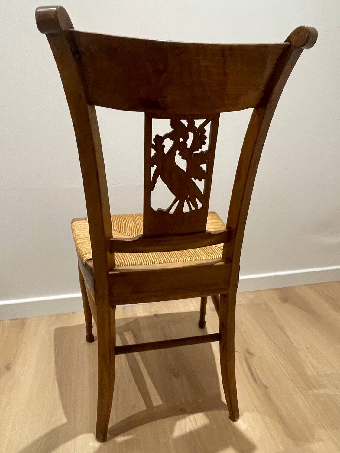 19th century straw chair with carved peacock back