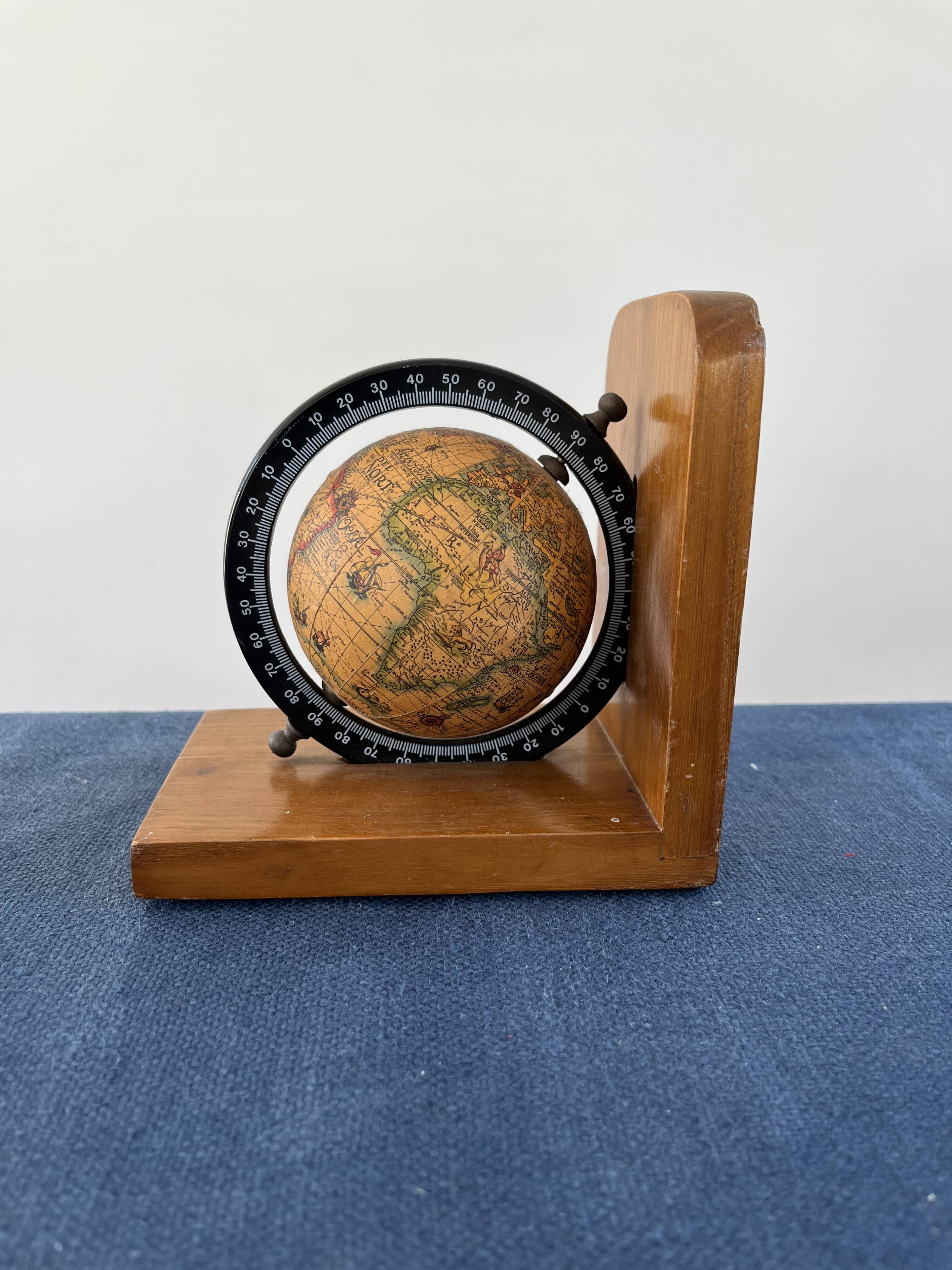 Rotating globe bookends on wooden base