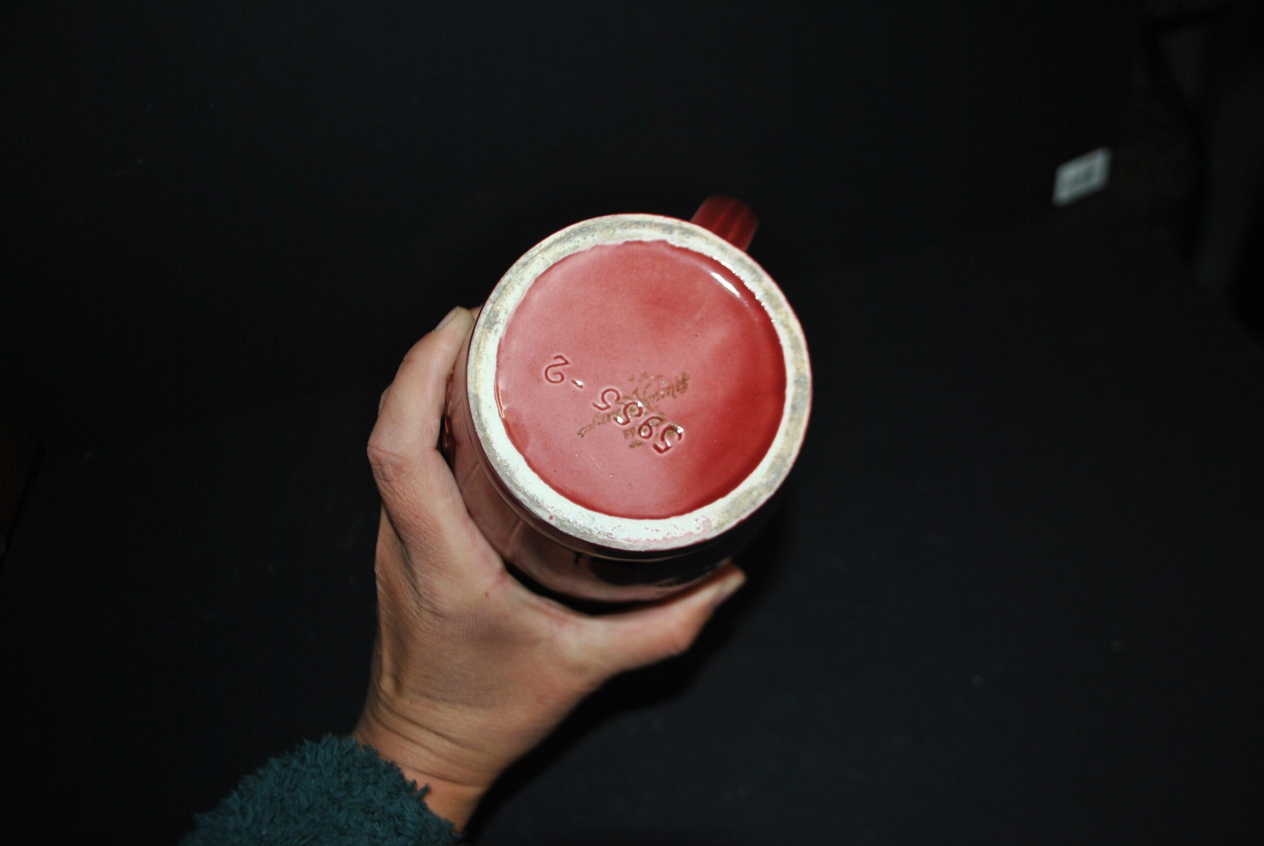 Sarreguemines wine jug in red slipware with grapevine decoration.