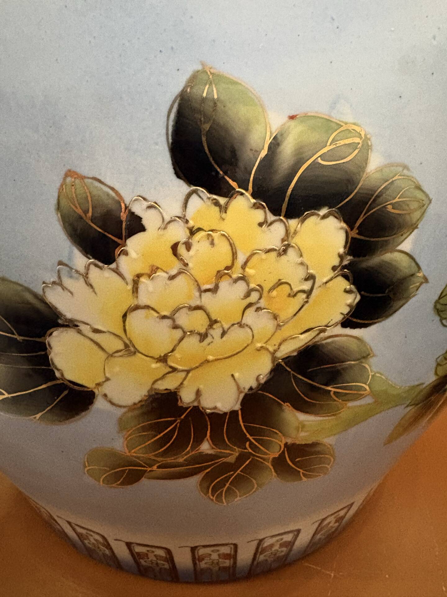 Antique porcelain vase with floral and bird decoration.