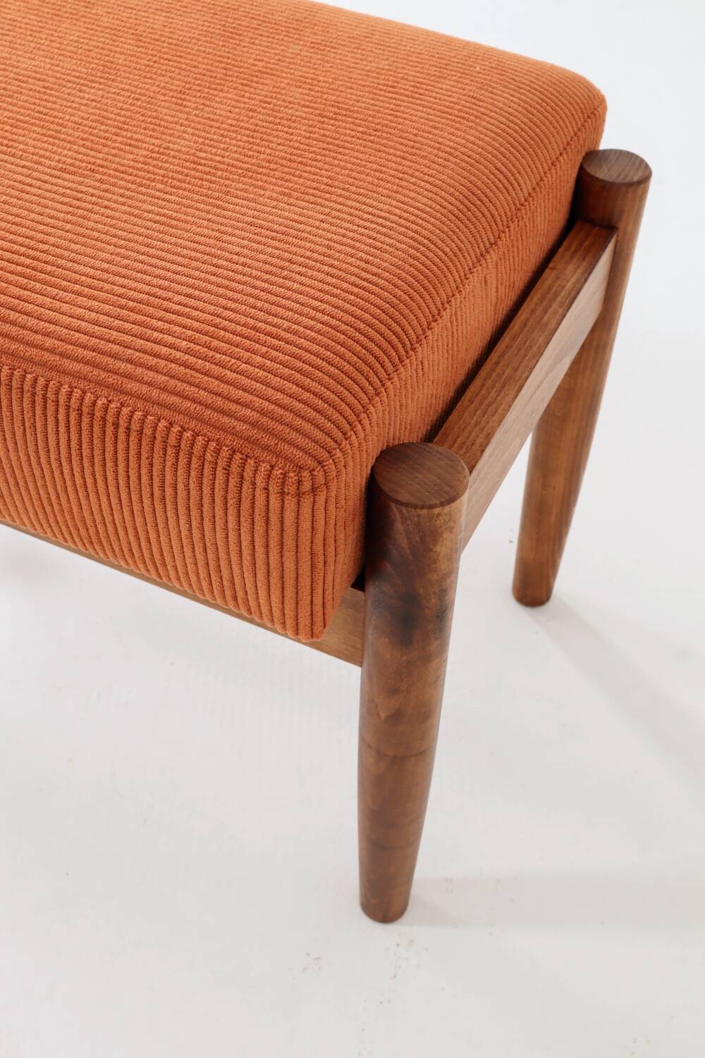 Vintage armchair and footrest in orange corduroy.