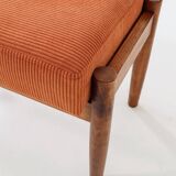 Vintage armchair and footrest in orange corduroy.