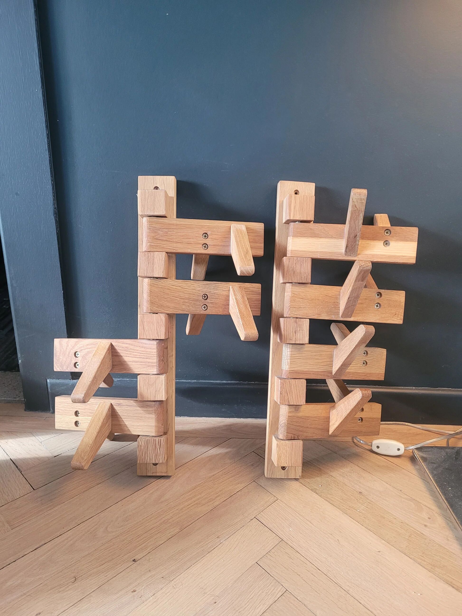 Articulated vertical wall coat rack