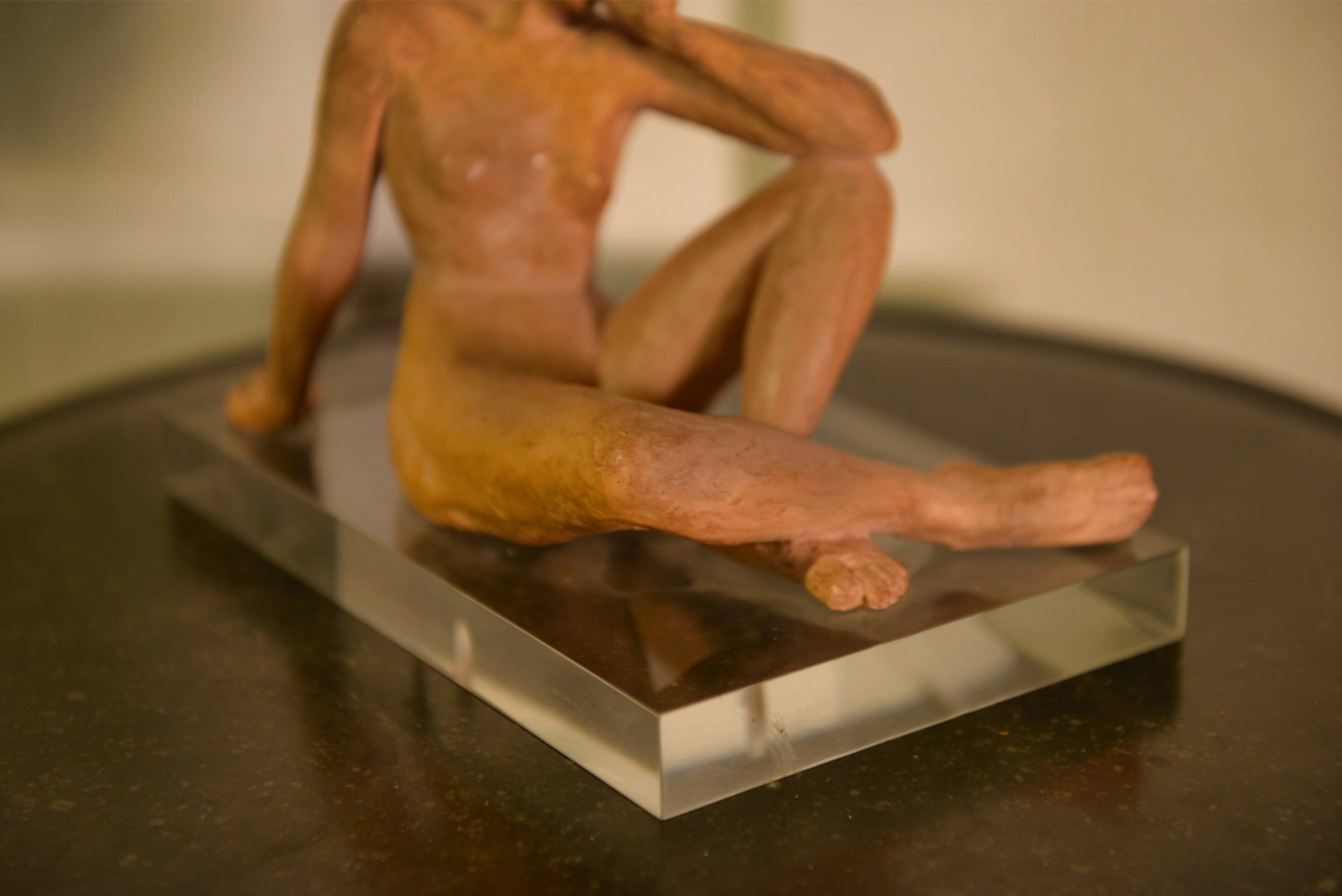 Terracotta sculpture of a seated woman by Norbert Treca contemporary art.