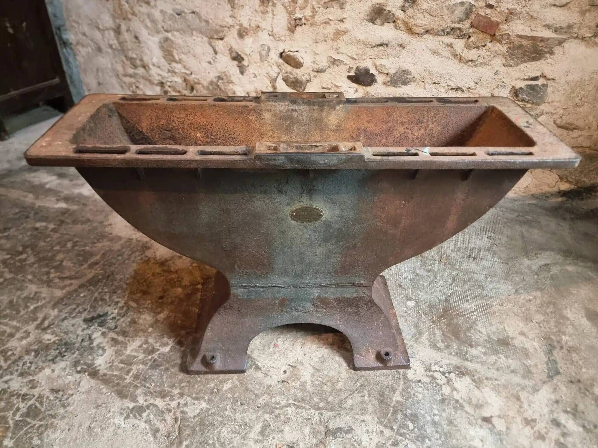 Old French industrial table with a cast iron base and a pine top.