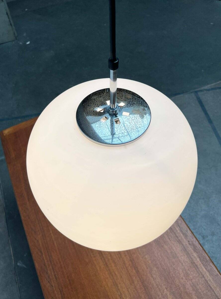 Minimalist suspended glass ball lamp from the vintage German space age by Glashütte Limburg, 1970s.