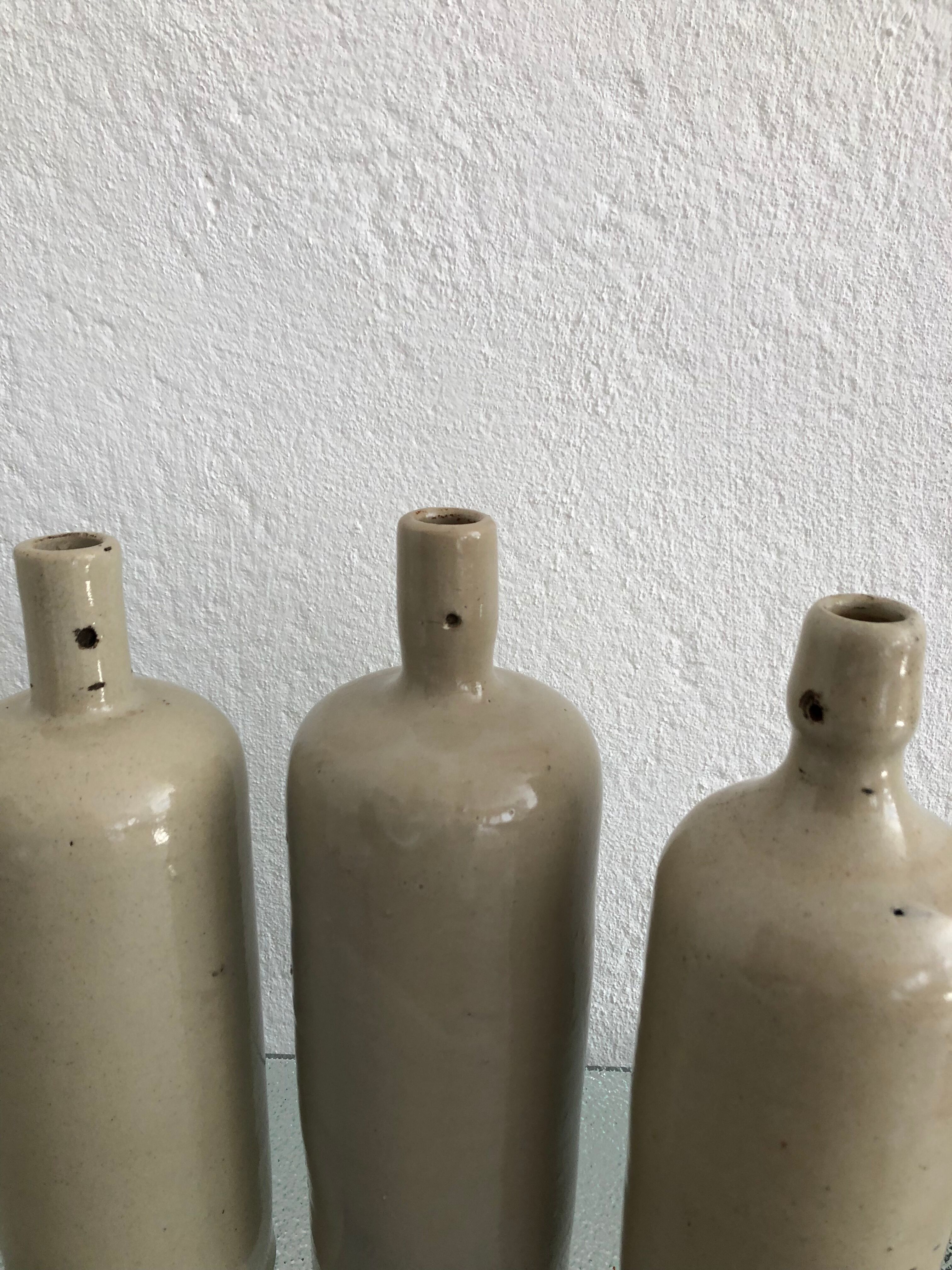 Trio of vintage stoneware bottles