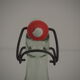 Bottle with mechanical closure in white glass