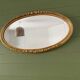 Large gold oval wall mirror