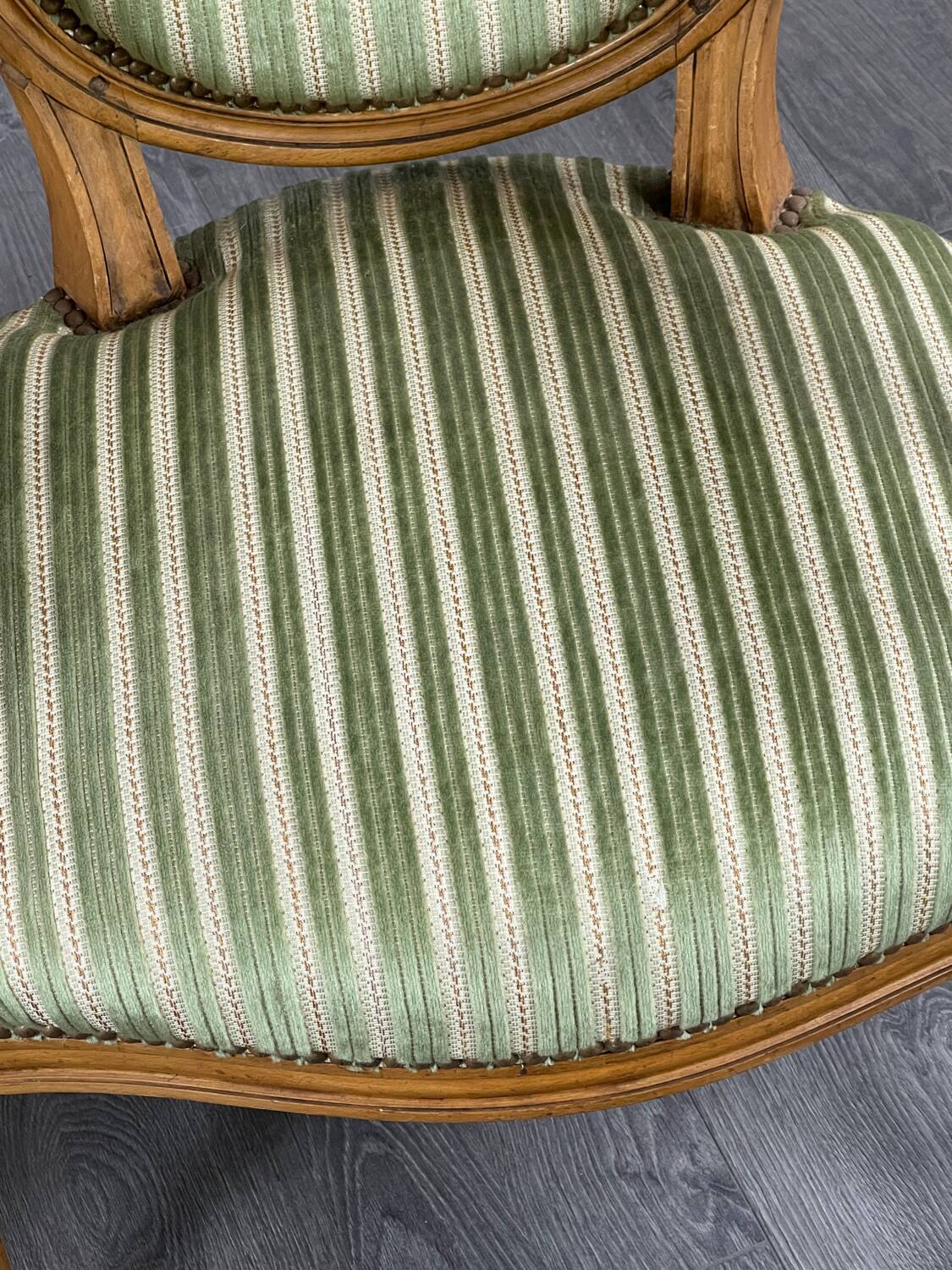 Pair of Louis XVI style armchairs in striped green fabric, 20th century.