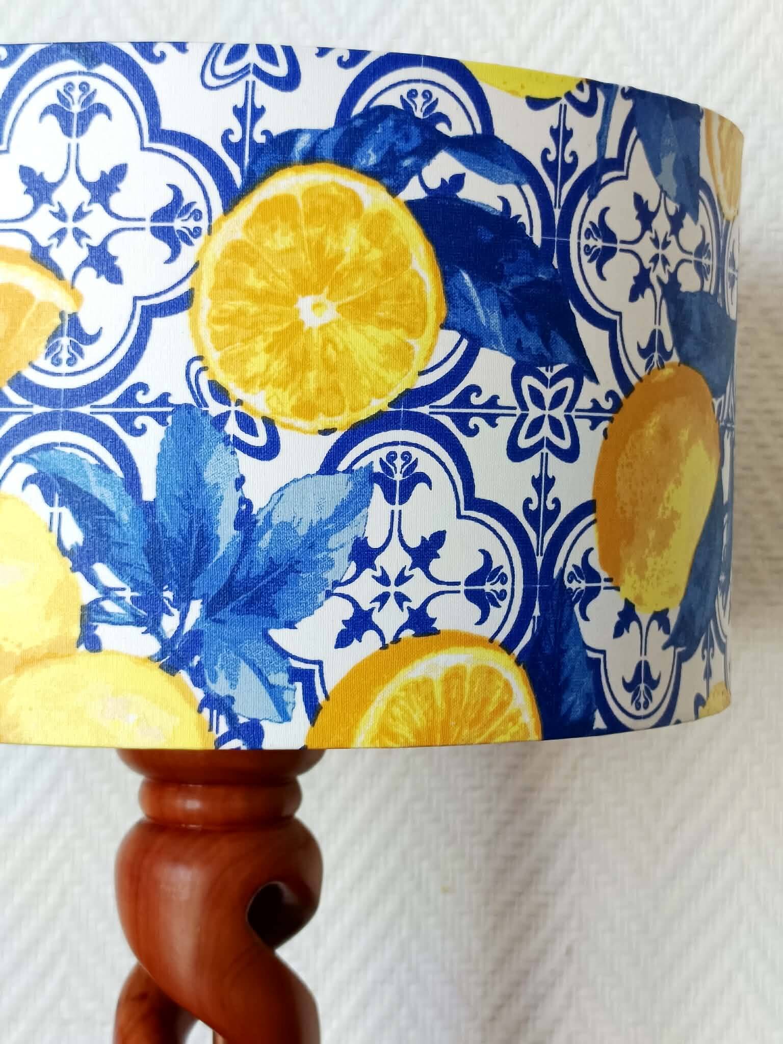 Turned wooden lamp with a lampshade featuring lemon tiles.
