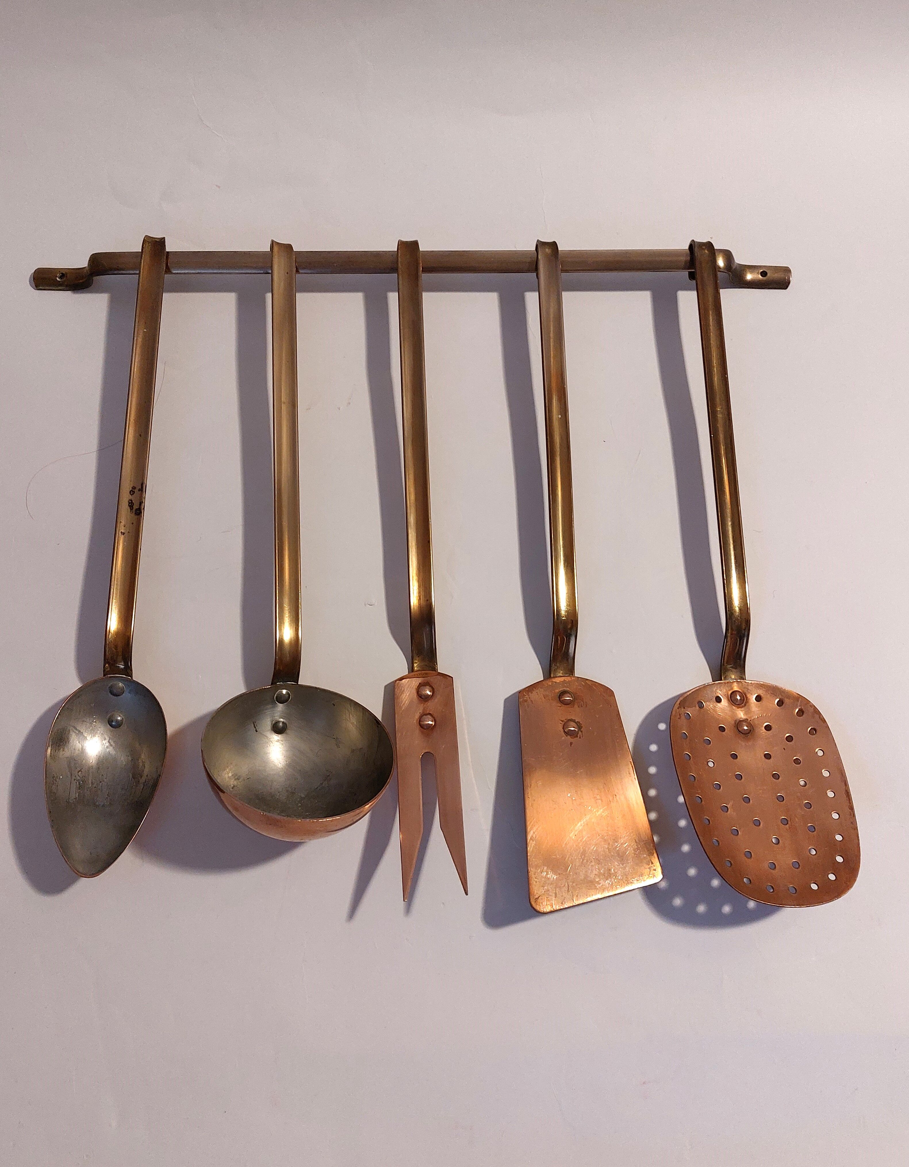 Vintage copper and brass kitchen utensils.